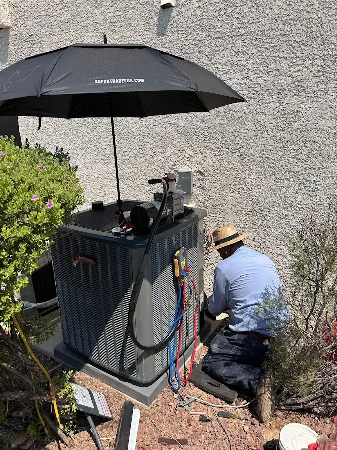 HVAC technician performing outdoor AC maintenance in Lake Worth Beach